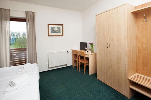 a bathroom with a desk and a computer in a room at Hotel Panska Licha in Brno