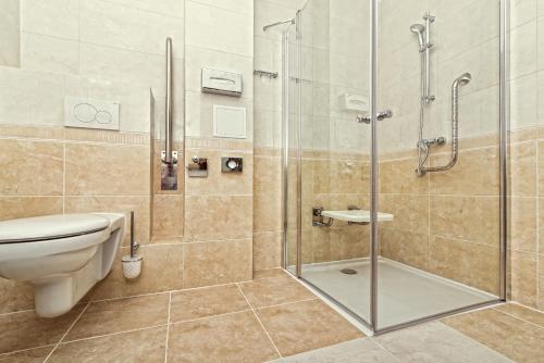 a bathroom with a toilet and a glass shower at Maestro Inn in Krasnystaw
