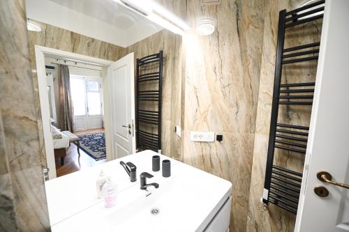 a bathroom with a white sink and a mirror at Casa ABA in Sibiu