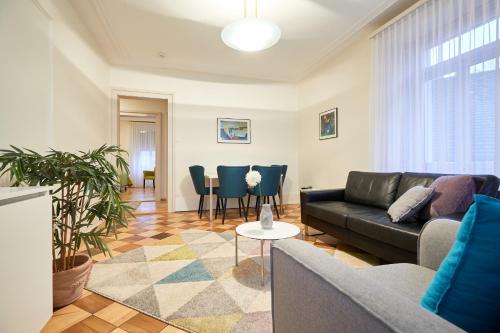 a living room with a couch and chairs at Hotel Schmid & Alfa in Brunnen