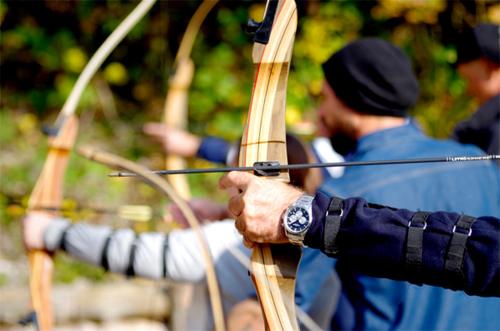 a man is holding a bow and arrow at Pension Almhof Baumgarten in Bad Reichenhall
