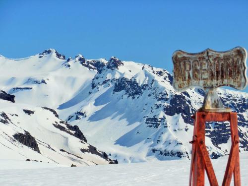 a sign on top of a snow covered mountain at Lodge Tikilen Caviahue in Caviahue