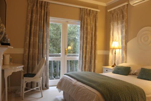a bedroom with a bed and a window at Villa Lugano Guesthouse in Johannesburg
