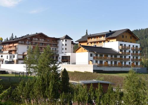 a group of apartment buildings in a city at Das Alpenhaus Katschberg 1640 inkl Lungau Card in Katschberghöhe
