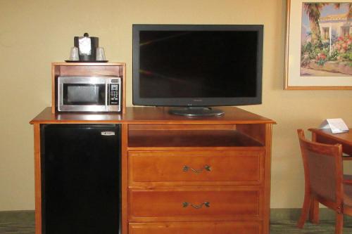 a television and a microwave on top of a wooden dresser at Quality Inn Casa Grande I-10 in Casa Grande