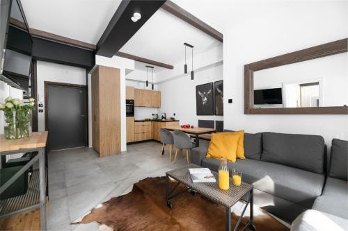 a living room with a couch and a table at Aparthotel Narciarska 2 in Korbielów