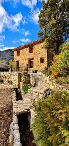 a stone house with a stone path leading to it at Saluda Alta in Castril