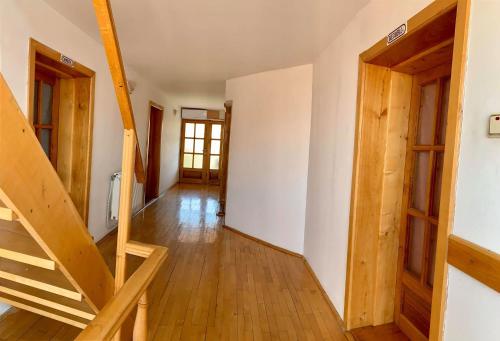 a wooden staircase in a room with a door at Casa Debora in Haţeg