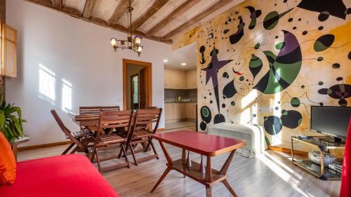 a living room with a table and a rock wall at Apartamentos El Pintor in Barcelona