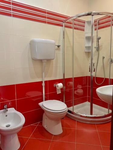 a bathroom with a toilet and a shower and a sink at Albergo Cinzia in Florence