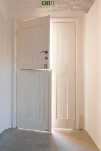 a white garage door in a room at Yialos Ios Hotel in Ios Chora
