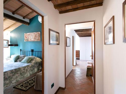 a bedroom with blue walls and a bed in a room at Villa Santa Chiara in Siena