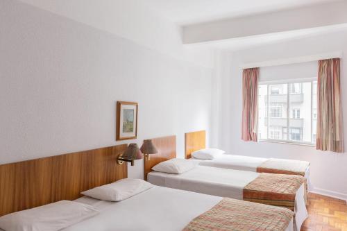 Postel nebo postele na pokoji v ubytování Hotel Rojas All Suite