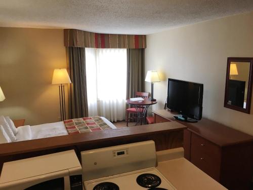 a hotel room with a bed and a television at Charlottetown Inn & Conference Centre in Charlottetown