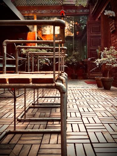 a metal chair sitting on a tiled floor at 12th Avenue in Lahore