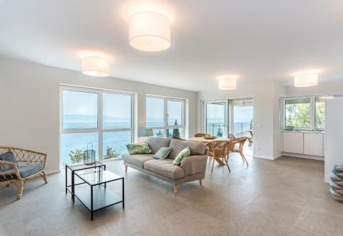 a living room with a couch and a table at House 61 Sveta Marina in Sveta Marina