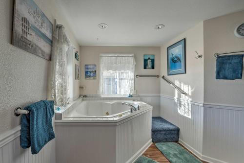a white bathroom with a tub and a window at Eagles View Condo in Ocean Shores with 3 Balconies in Ocean Shores