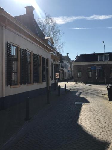 a cobblestone street in a town with buildings at De vijgenhof in Appingedam