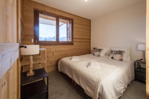 Säng eller sängar i ett rum på ODYSSEE ARC02 Appartement sur les pistes avec vue panoramique