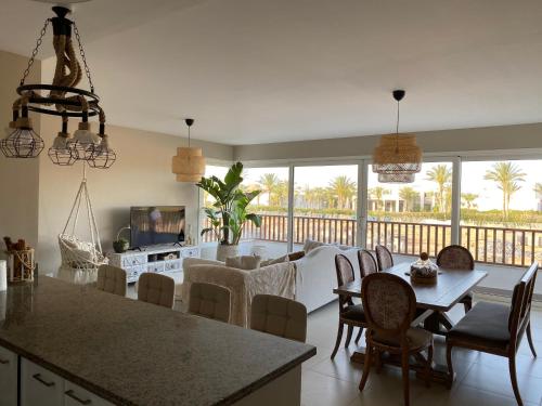 a kitchen and living room with a table and chairs at Almaza bay Beach Town Chalet in Marsa Matruh