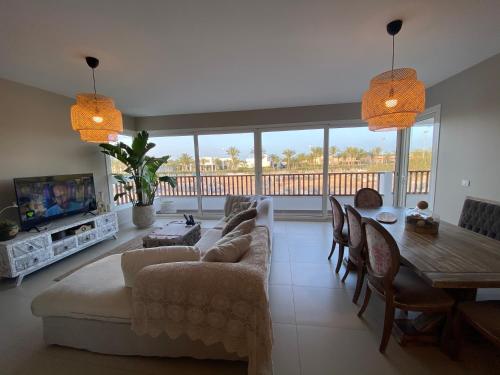 a living room with a couch and a table at Almaza bay Beach Town Chalet in Marsa Matruh