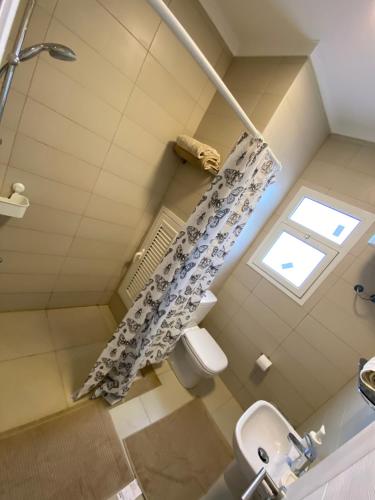a bathroom with a shower and a toilet and a window at Almaza bay Beach Town Chalet in Marsa Matruh