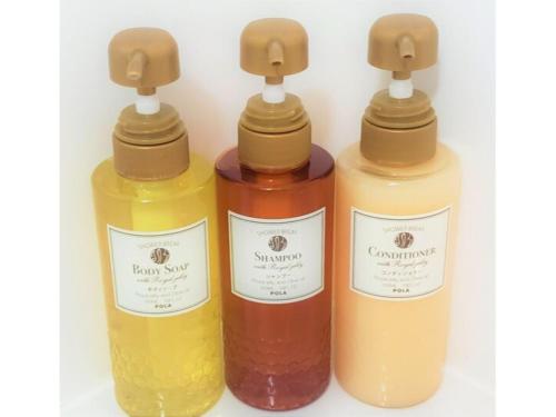 three bottles of different colored liquids sitting next to each other at Hotel Ascent Hamamatsu / Vacation STAY 79774 in Hamamatsu