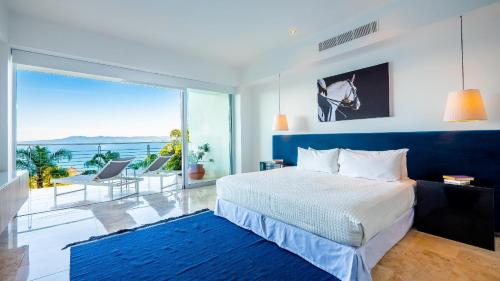 a bedroom with a bed and a view of the ocean at Paramount Bay - 308 Peaceful Luxury View 2 BR in Puerto Vallarta