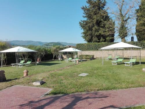 a group of chairs and umbrellas in a park at Sovana Hotel & Resort in Sovana