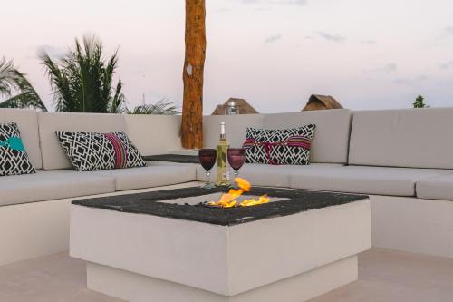 a fire pit in a living room with a couch at Hotel Boutique La Puerta Azul Beachfront - Adults Only in Holbox Island