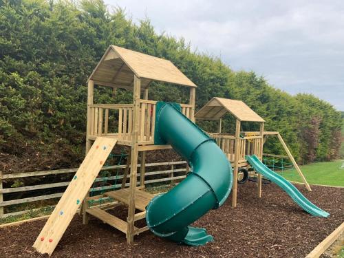 two playground equipment with slides in a park at Marina views, Kinsale, Hosted by Exquisite holiday homes, sleeps 20 in Kinsale