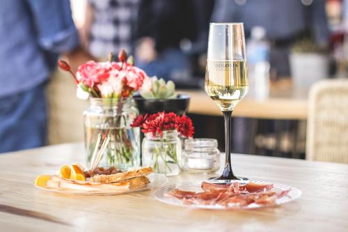 a glass of wine and a plate of food on a table at Hotel Rio Tequisquiapan in Tequisquiapan