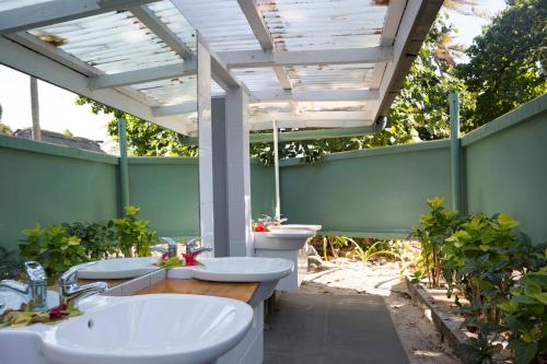 a bathroom with two sinks and two toilets at Beachcomber Island Resort in Beachcomber Island