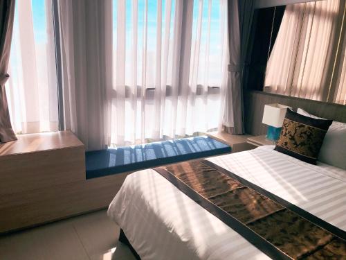 a hotel room with two beds and a window at Aurora Western Village in Ho Chi Minh City