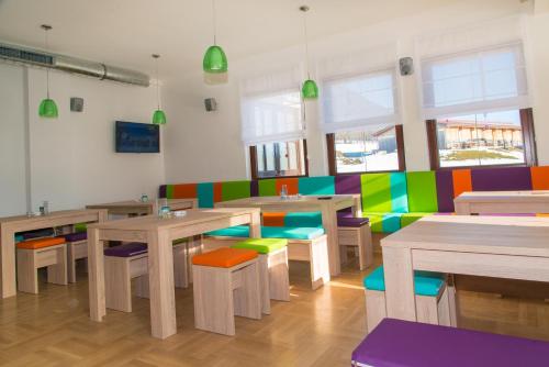 a brightly colored restaurant with tables and chairs at Hotel Stierer in Ramsau am Dachstein