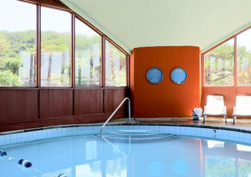 a swimming pool in a room with windows at Surftides Hotel in Lincoln City