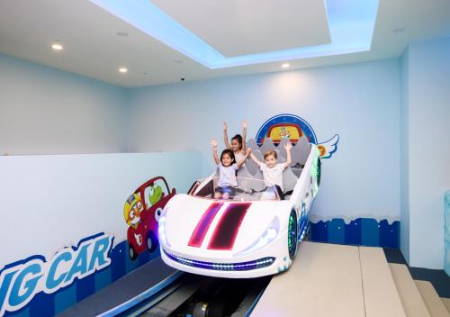 a family riding a roller coaster in a roller coaster park at Jpark Island Resort & Waterpark Cebu in Mactan