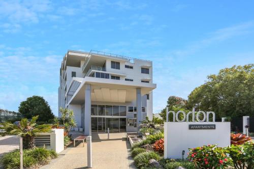 a large white building with a large window at Horton Apartments in Maroochydore