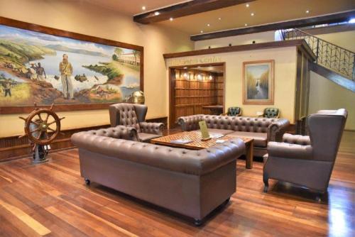 a large room with a table and chairs and a painting at Speke Hotel 1996 Ltd in Kampala