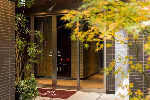 an entrance to a house with glass doors at Hotel Grand Bach Kyoto Select in Kyoto