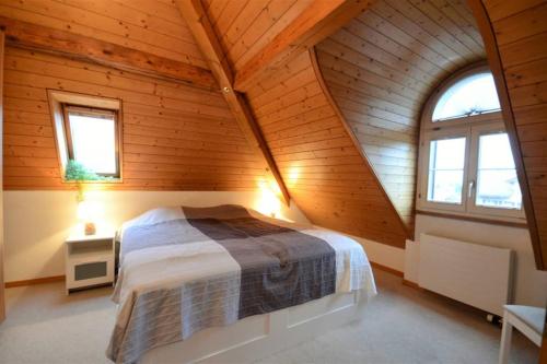 a bedroom with a bed in a wooden cabin at Modern Penthouse Apartment, close to everything in Matten
