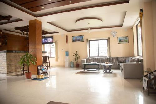 a living room with a couch and a table at Hotel Sublime in Pokhara