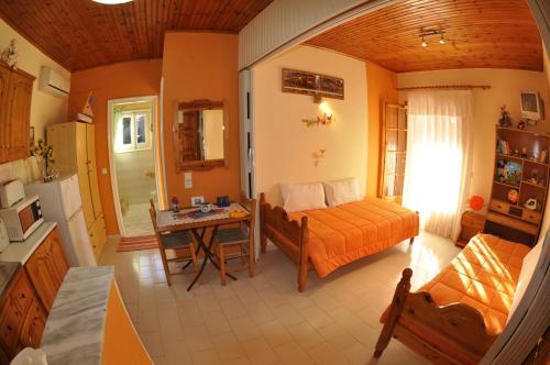 a bedroom with a bed and a table in a room at Paraskevi Apartments in Paleokastritsa