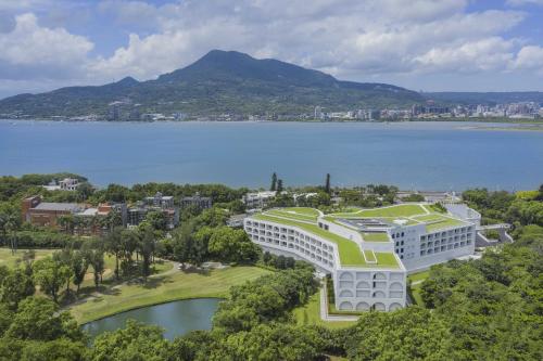 an aerial view of a resort with a body of water at Golden Tulip FAB Hotel New Taipei in Tamsui