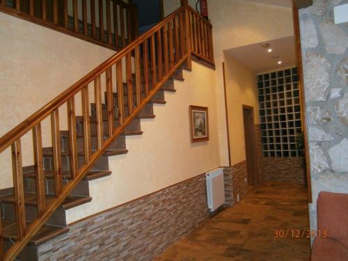 a wooden staircase in a home with a brick wall at Legaire Etxea in Ibarguren