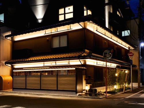 a building with lights on it at night at Rinn Shijo Nishinotoin in Kyoto