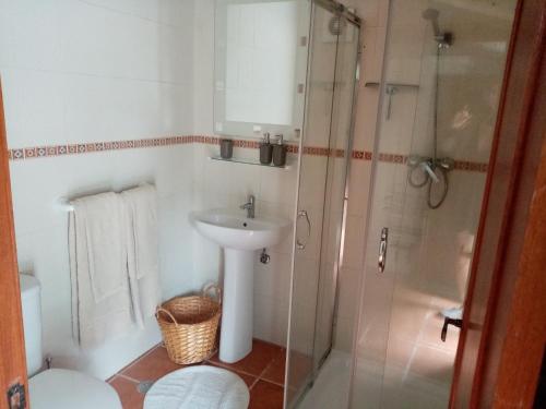 a bathroom with a sink and a shower at Flor da Ramila in Marvão