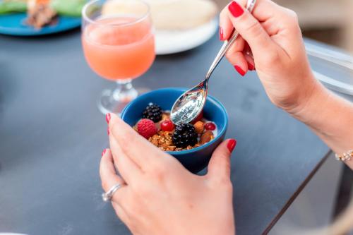 two women eating a bowl of cereal and fruit at Sofitel Agadir Thalassa Sea & Spa in Agadir