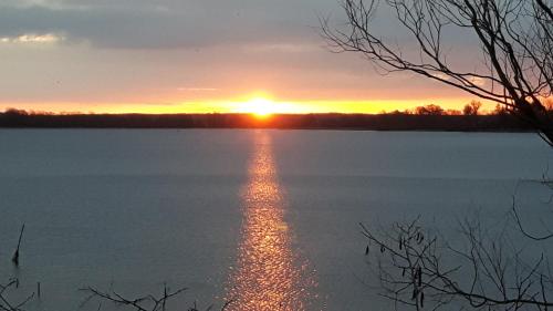 a sunset over a large body of water at Pension Am Dorfanger in Hohennauen