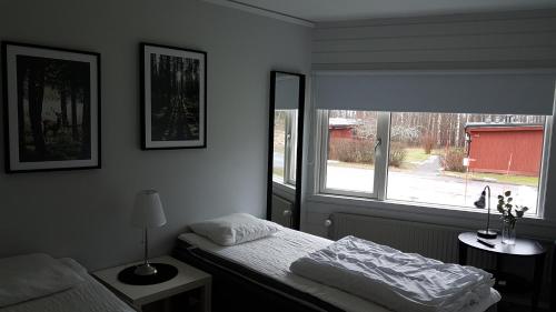 a bedroom with a bed and a window at Karlskoga Folkhögskola Vandrarhem Udden in Karlskoga